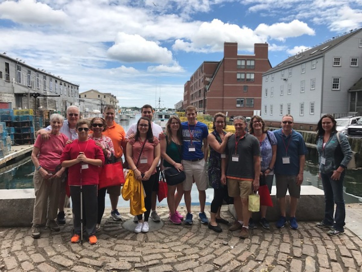 a group of people standing on a wharf