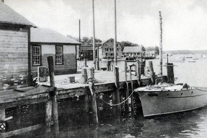 a boat is docked next to a body of water