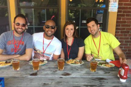 a group of people sitting at a table eating food